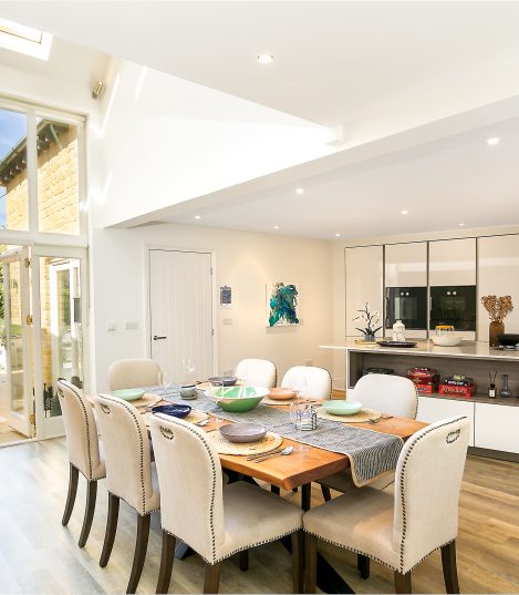 Spacious open-plan kitchen and dining room with bi-fold doors in a Red Kite Hosts managed holiday let in the Cotswolds
